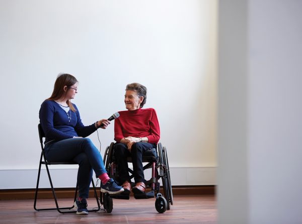 A woman in a wheelchair being interviewed by another woman