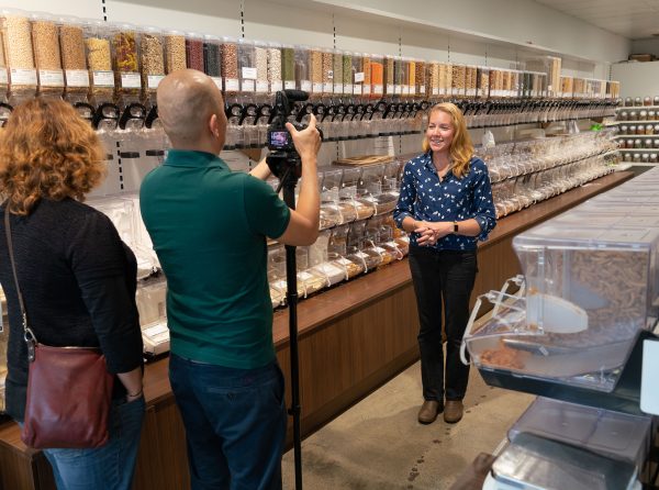 Behind-the-scenes photo shoot of a women in a bulk food store