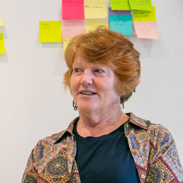 Sue Crock in front of a wall with post it notes
