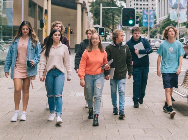 A group of IDEA Academy student walking down a city street